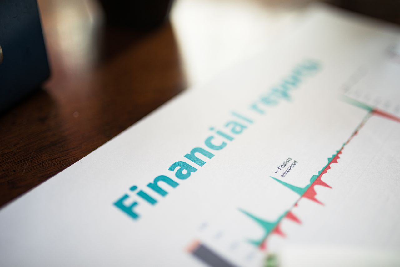 The Art of Drawing Readers In: Your attractive post title goes here Detailed view of a financial report with a focus on graphs and data analysis.